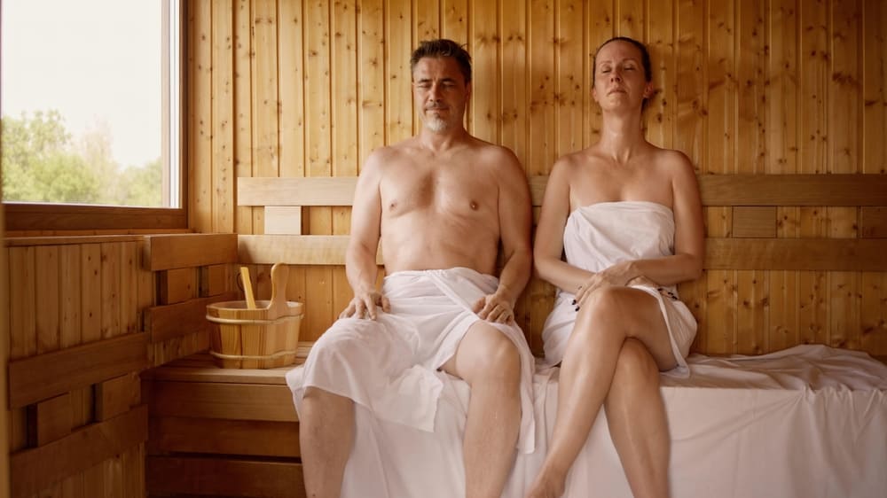 Couple relaxing in hot sauna.