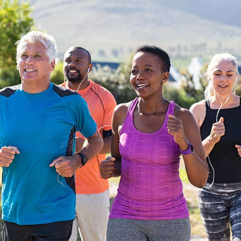 Group Photo of Running People of Different Ages Smiling