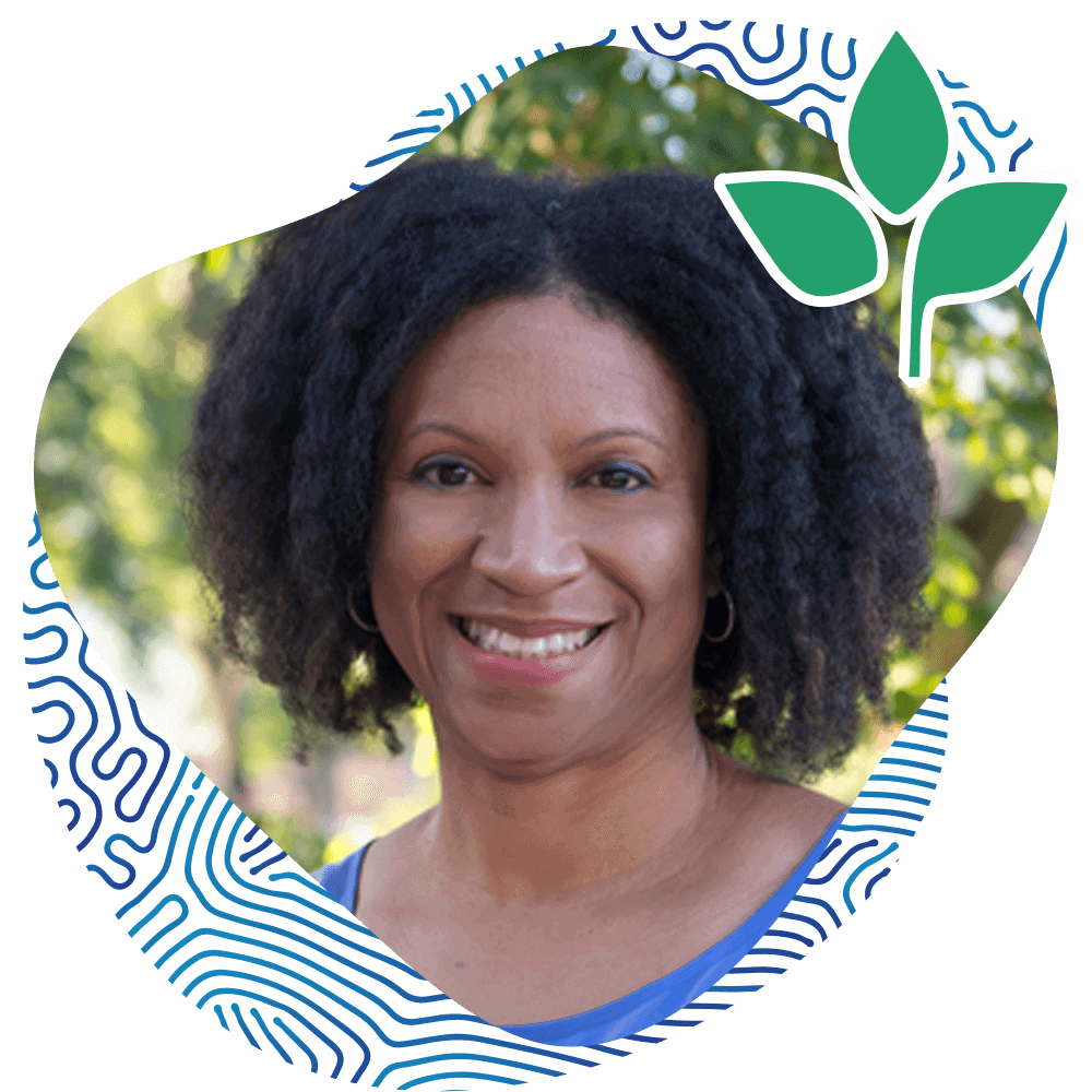 Portrait of Afro-American Lady Smiling at the Camera Wearing a Blue Tee with a Natural Background. Sasha