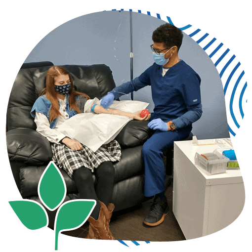 Photo of Surgical Procedure being done on a teenage girl by an adult doctor wearing a blue coat