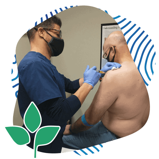 Photo of Surgical Procedure being done on a senior's shoulder by an adult doctor wearing a blue coat